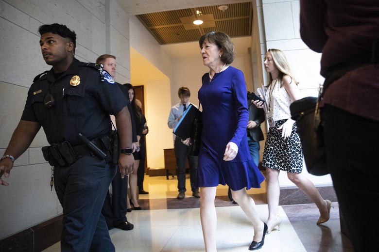Collins walking behind a security guard.